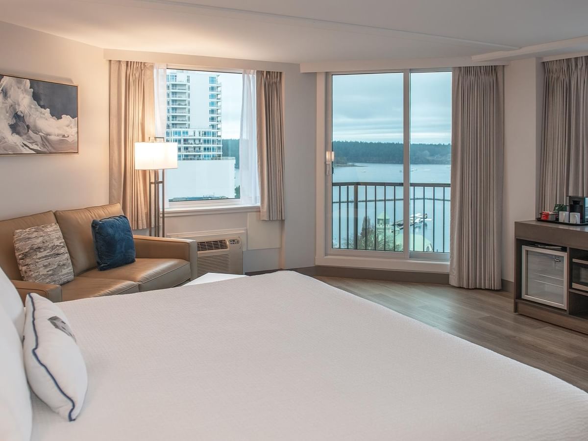 King bed, couch, and balcony with ocean view in Coast Premium King room at Coast Bastion Hotel in Nanaimo.
