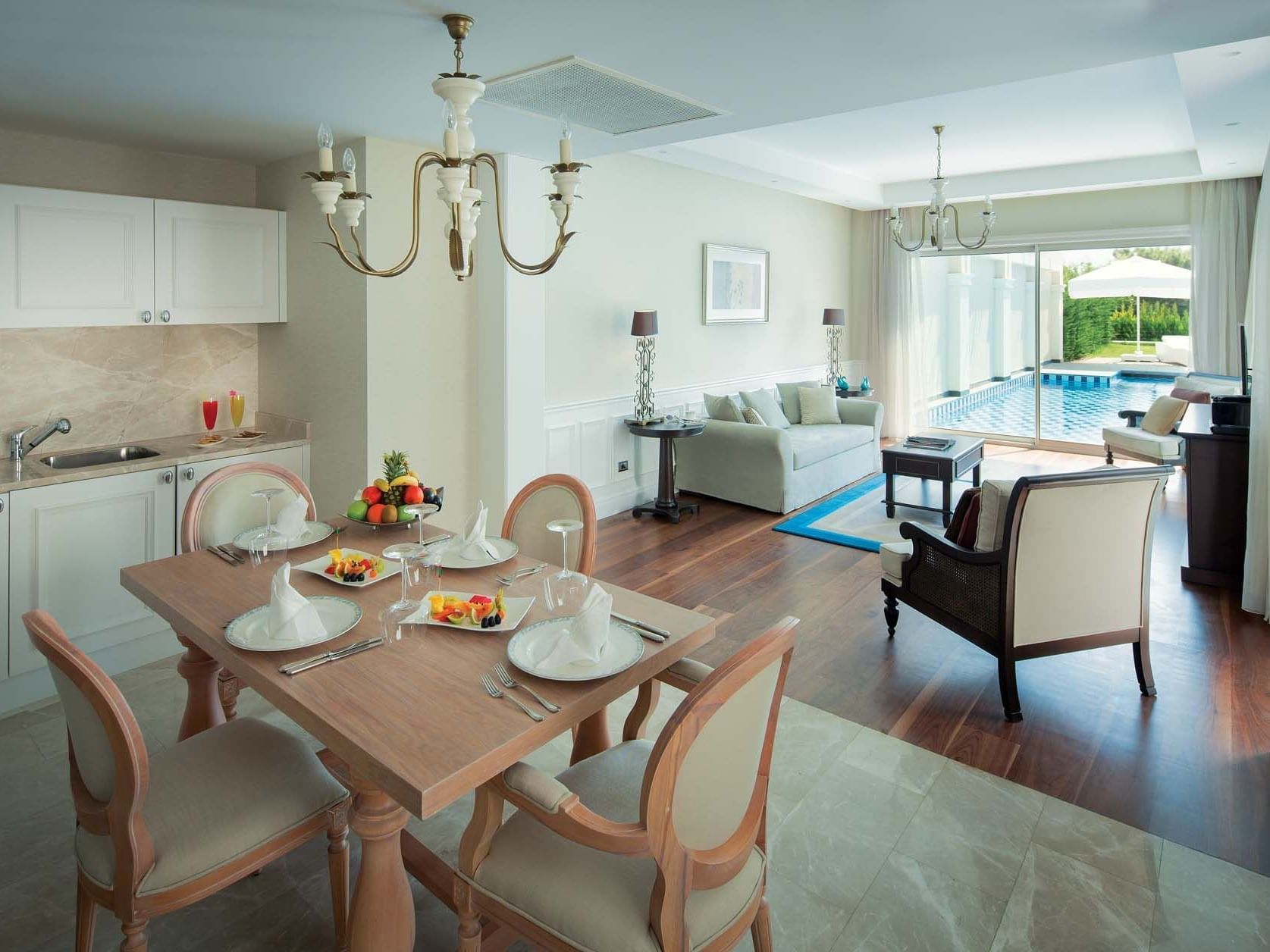 Dining table by living area in Exclusive Villa Pool with wooden floors at Titanic Deluxe Golf Belek
