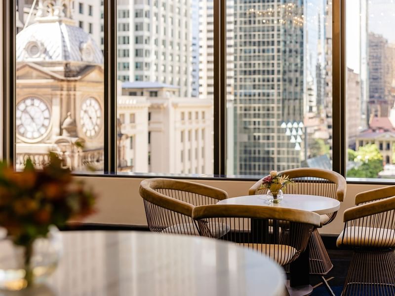 Ann St Lobby seating area with modern chairs, table, and city views at Sofitel Brisbane Central