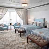 Twin beds In Deluxe room with sofas at Palazzo Versace Dubai