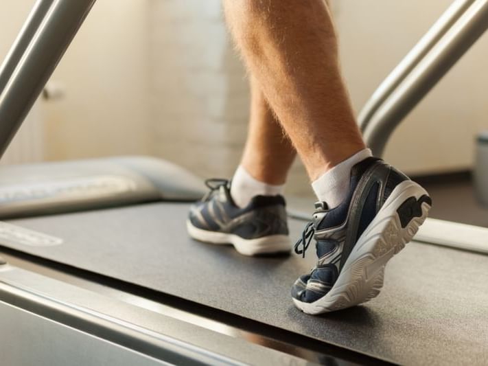 Closeup of man running on a treadmill at White Mountain Hotel 