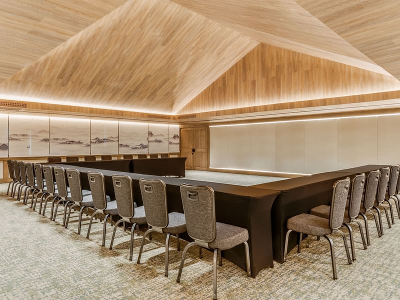 Elegant conference room with a wooden ceiling and carpeted floor at Grand Fiesta Americana