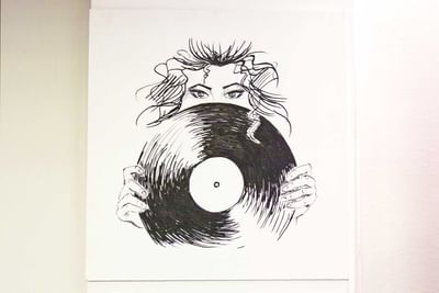Wall picture of a women holding a music record at Hotel Nologo