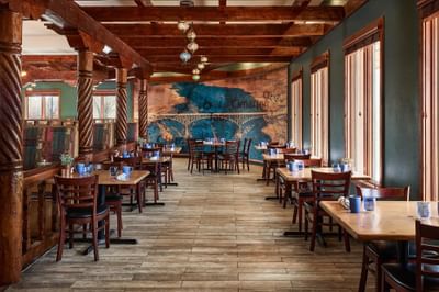restaurant seating with mural on wall