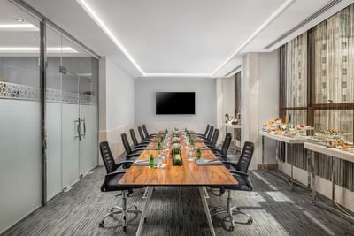Long table & TV in a Meeting room, Elaf Al Taqwa Hotel