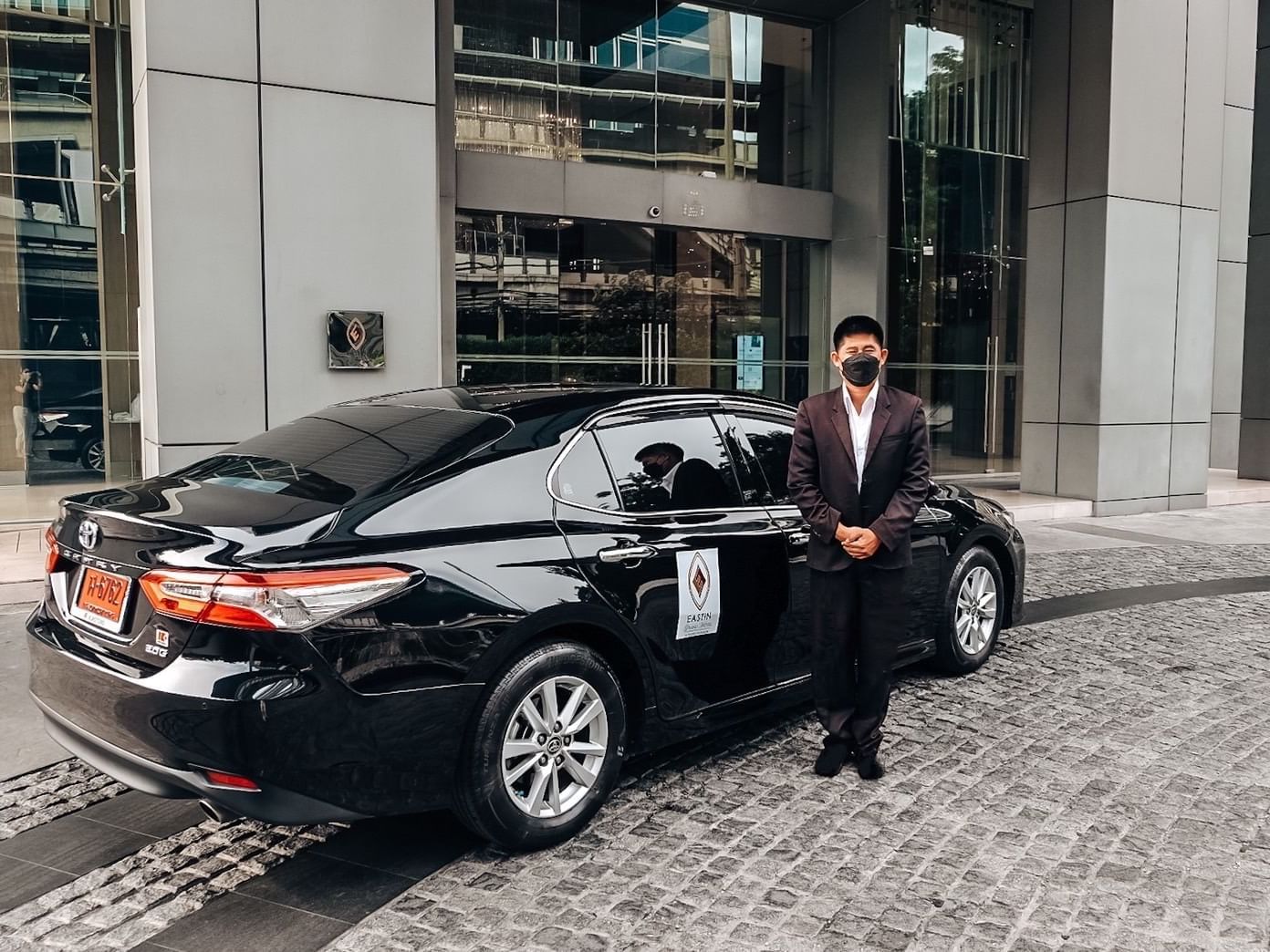 Chauffeur standing by the Limousine car at Eastin Grand Hotel Sathorn