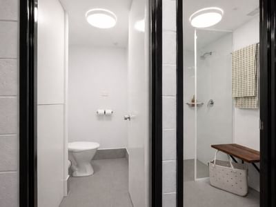 Modern bathroom with white toilet and shower stall at UniLodge at Curtin University Guild House.