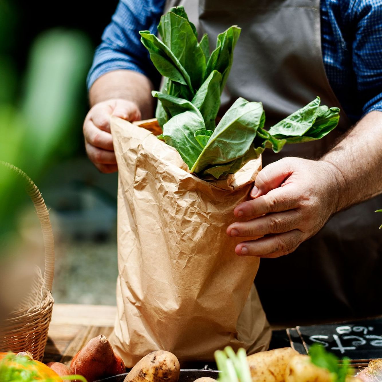 Man bagging beets at a farmers market.