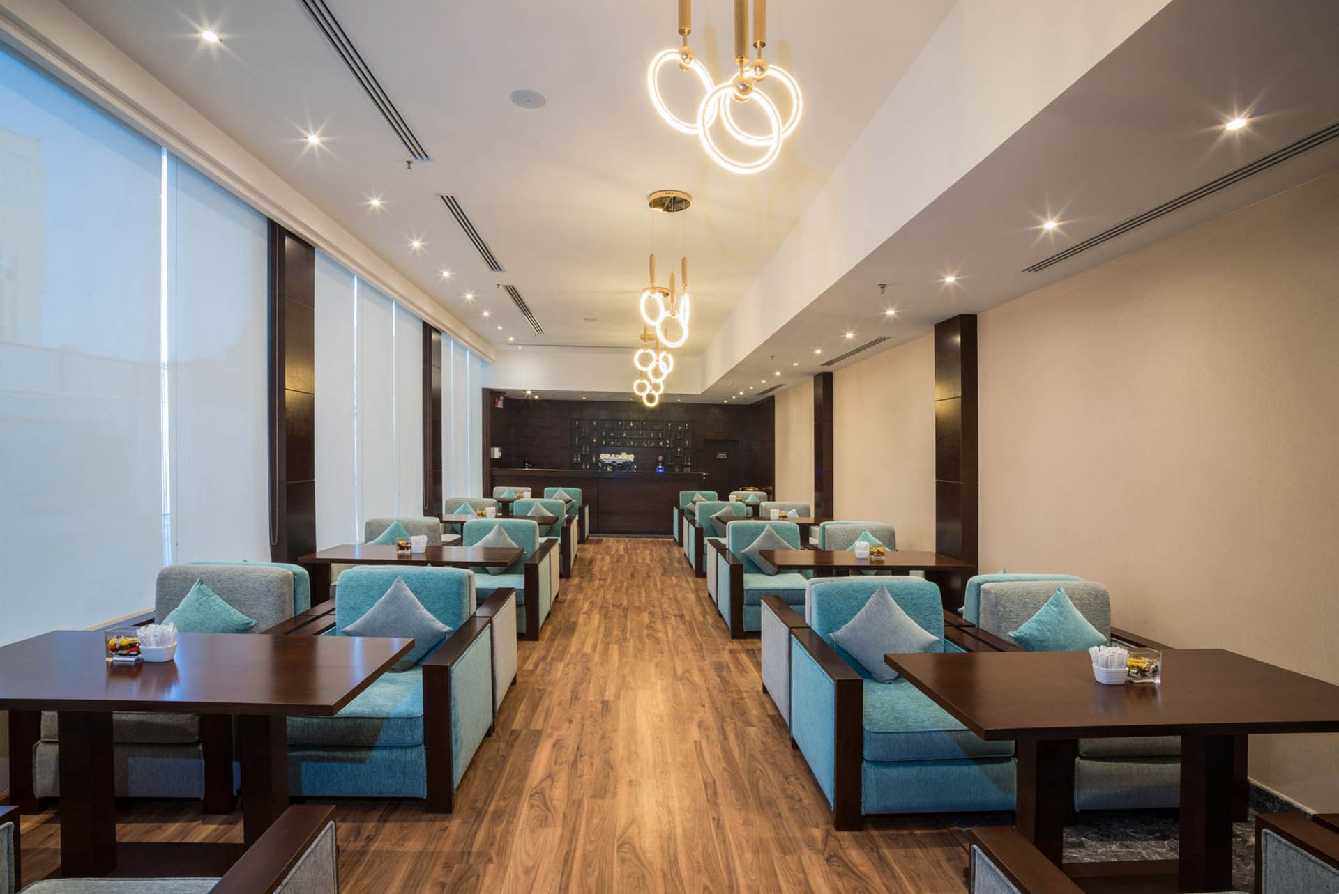 Arranged dining tables in the Lobby Bar Café at Naviti By Warwick Dammam