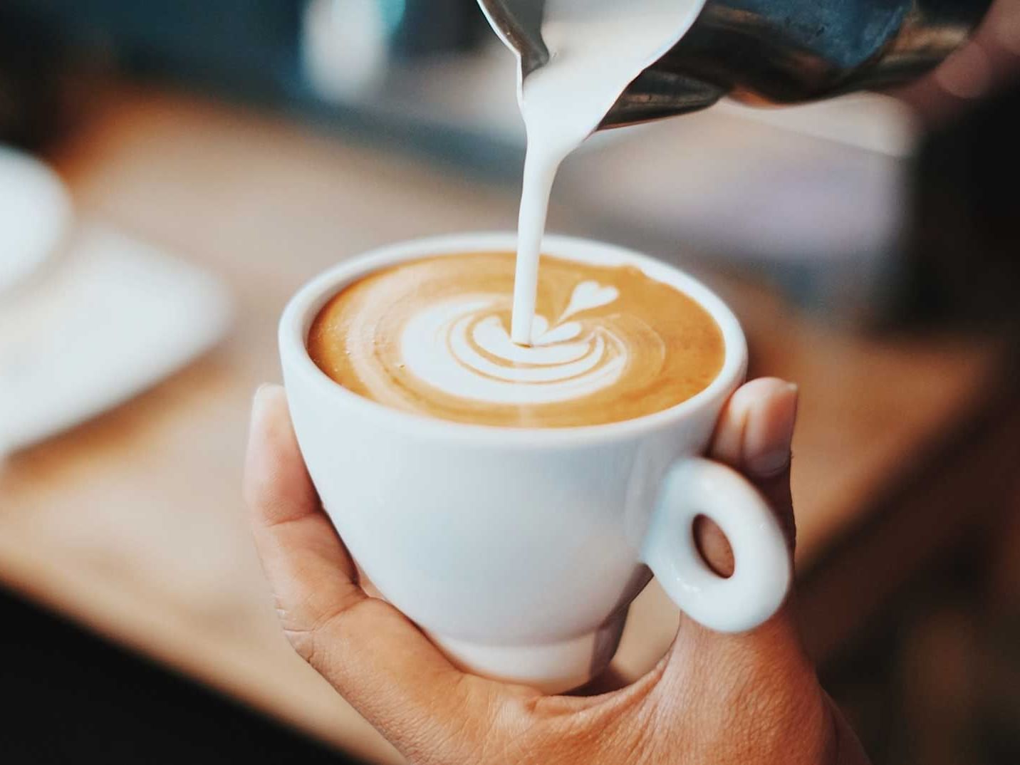 Pouring creamer in a coffee, Garden City Café, Discovery Samal