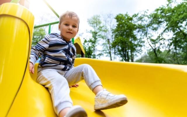 kid on slide at st johns lye park in woking