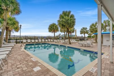 Outdoor swimming pool with arranged pool beds at The Yachtsman Resort