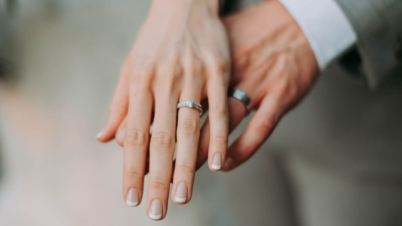 A couple with new wedding rings holding hands