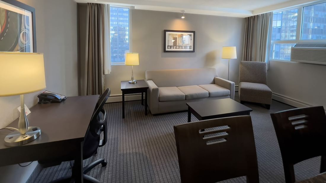 Hotel suite with sofa, table, working table, and chairs