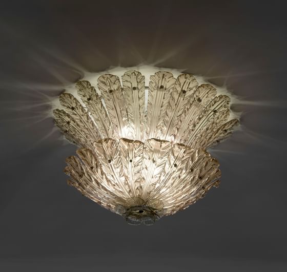 Glass ceiling light featuring delicate flower pattern at Bettoja Hotels Group