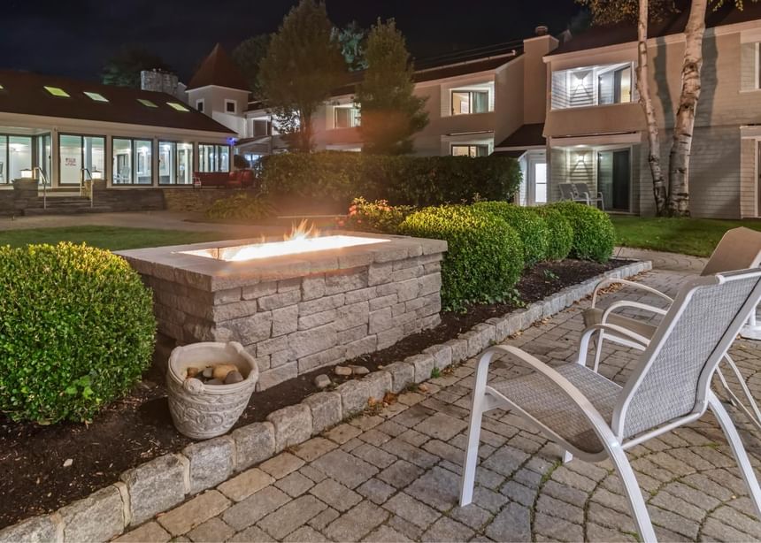 Outdoor sitting area by the stove at Ogunquit Collection