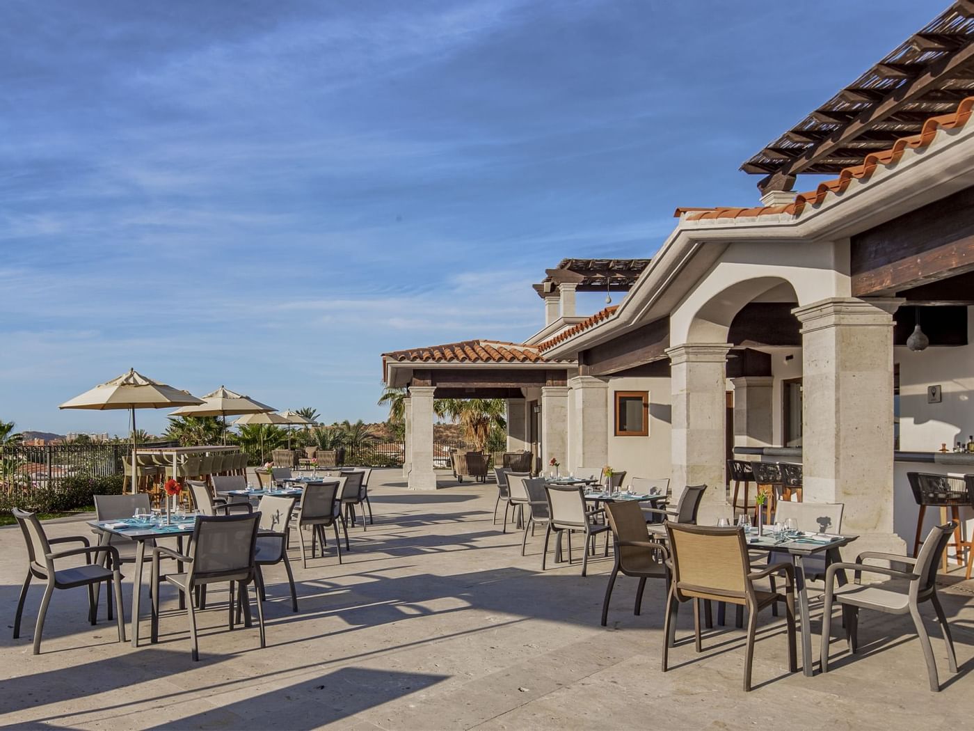 Outdoor dining table setup on the Mai Restaurant terrace at Live Aqua Resorts