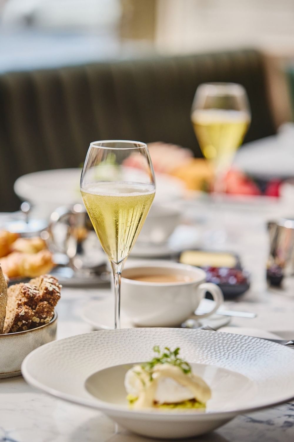 Elegant afternoon tea with champagne flutes, pastries, and plated appetizers at The Bedford Hotel Belfast