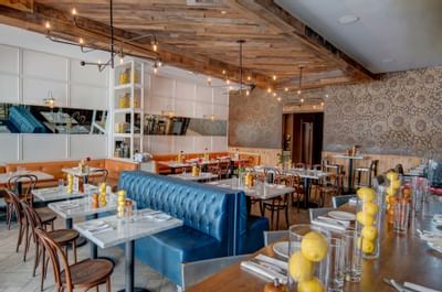 restaurant dining room with tables, booths and bar