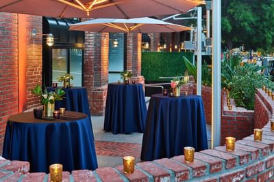 Cocktail tables arranged on a terrace at Hotel Republic San Diego