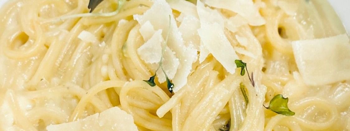 Spaghetti in creamy sauce with large parmesan shavings under micro herbs in Abbiocco at Warwick Paradise Island Bahamas