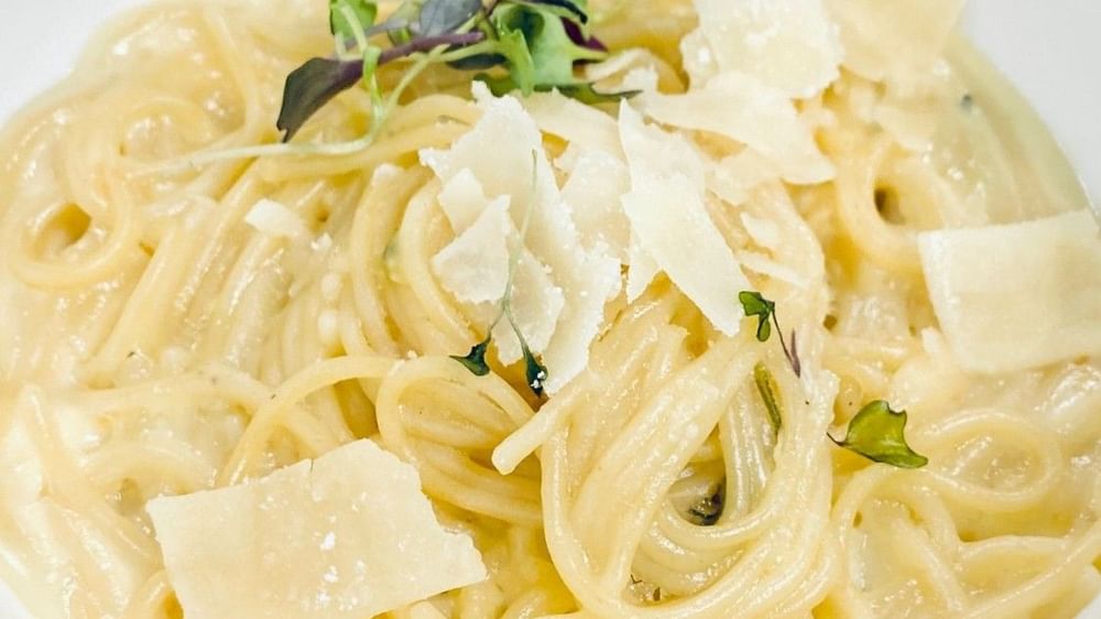 Spaghetti in creamy sauce with large parmesan shavings under micro herbs in Abbiocco at Warwick Paradise Island Bahamas