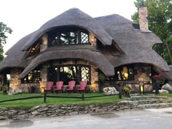 Exterior view of Mushroom House with a garden and lounge area near The Earl