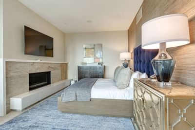TV & fireplace facing king bed in a bedroom at Stein Eriksen Residences