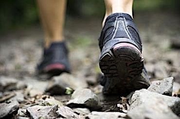 Close photo of sneakers walking on rocks