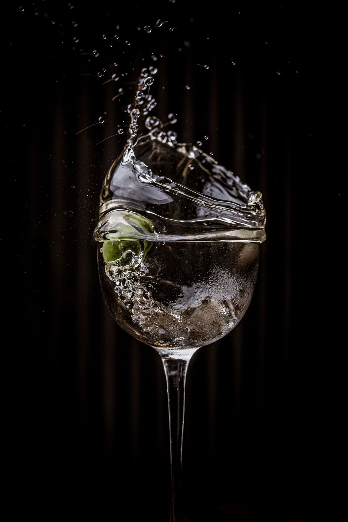 A martini cocktail of a splash olive at The May Fair Bar
