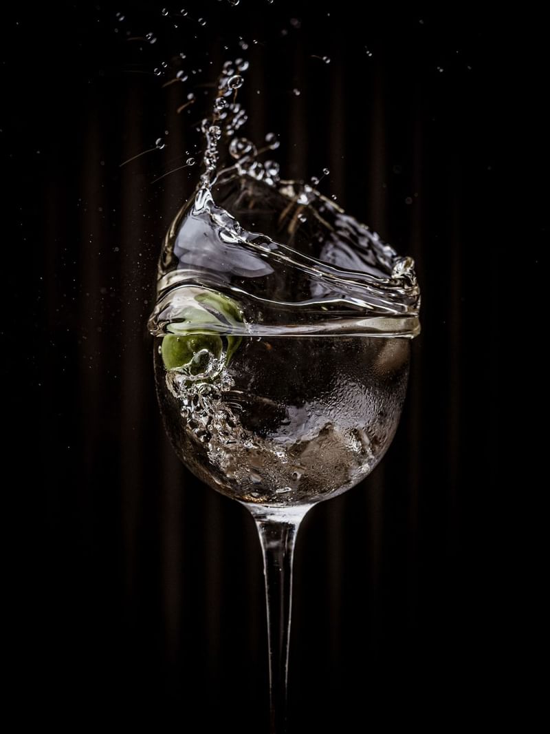 A martini cocktail of a splash olive at The May Fair Bar