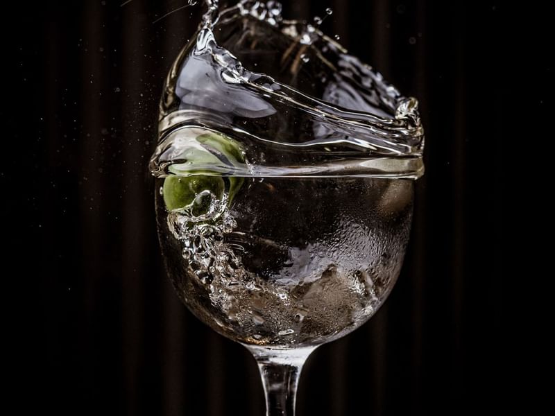 A martini cocktail of a splash olive at The May Fair Bar