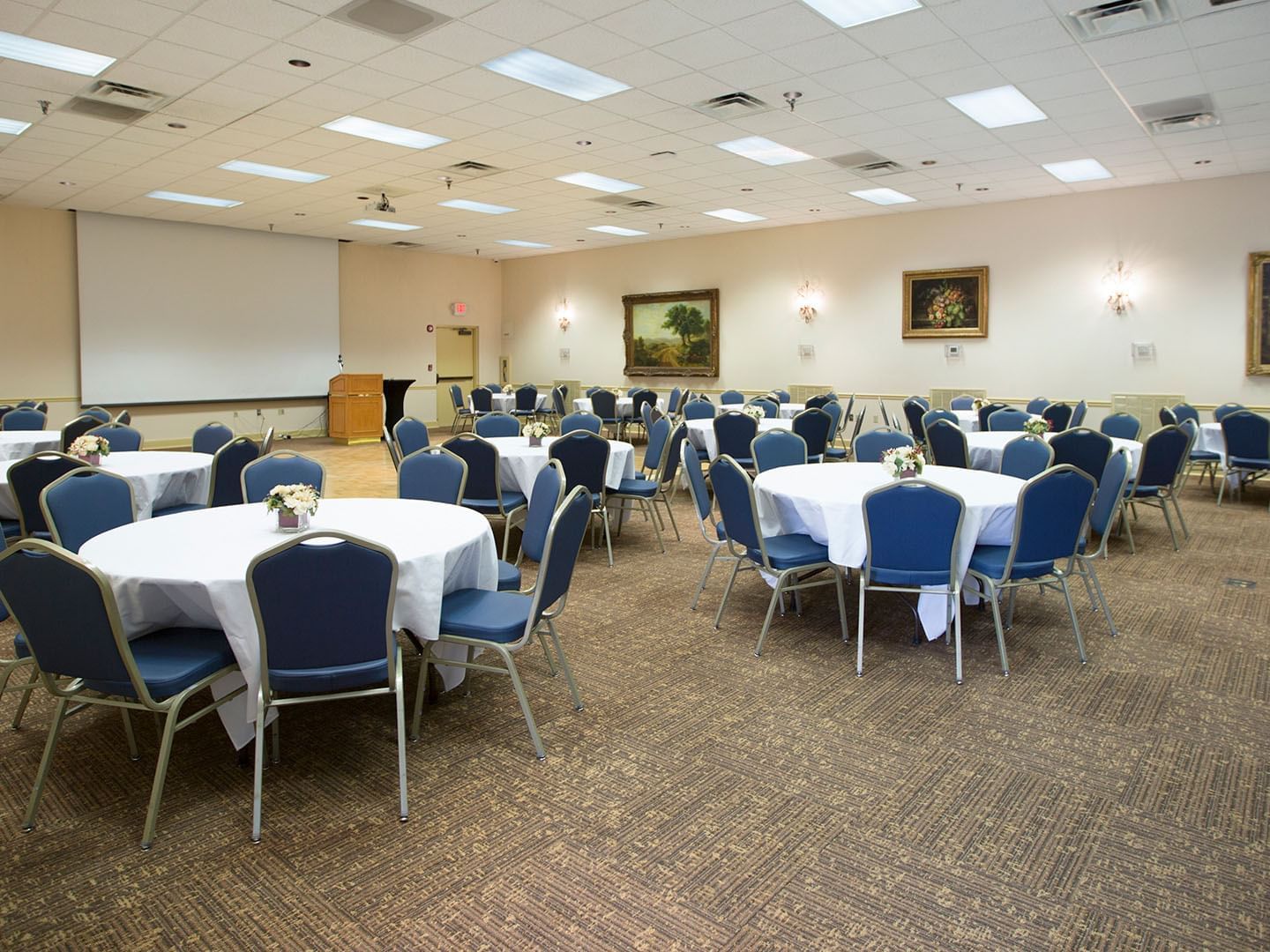 Round banquet tables arranged in a Hall at Music Road Resort