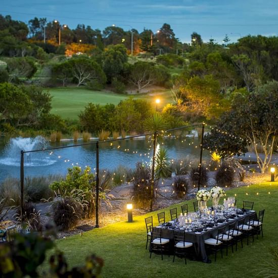 lakeside lawn conference with lots of lighting and black table setting