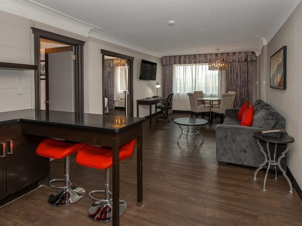 Spacious Coast King Suite with kitchenette, dining area, and living space at Coast Calgary University Area Hotel by APA