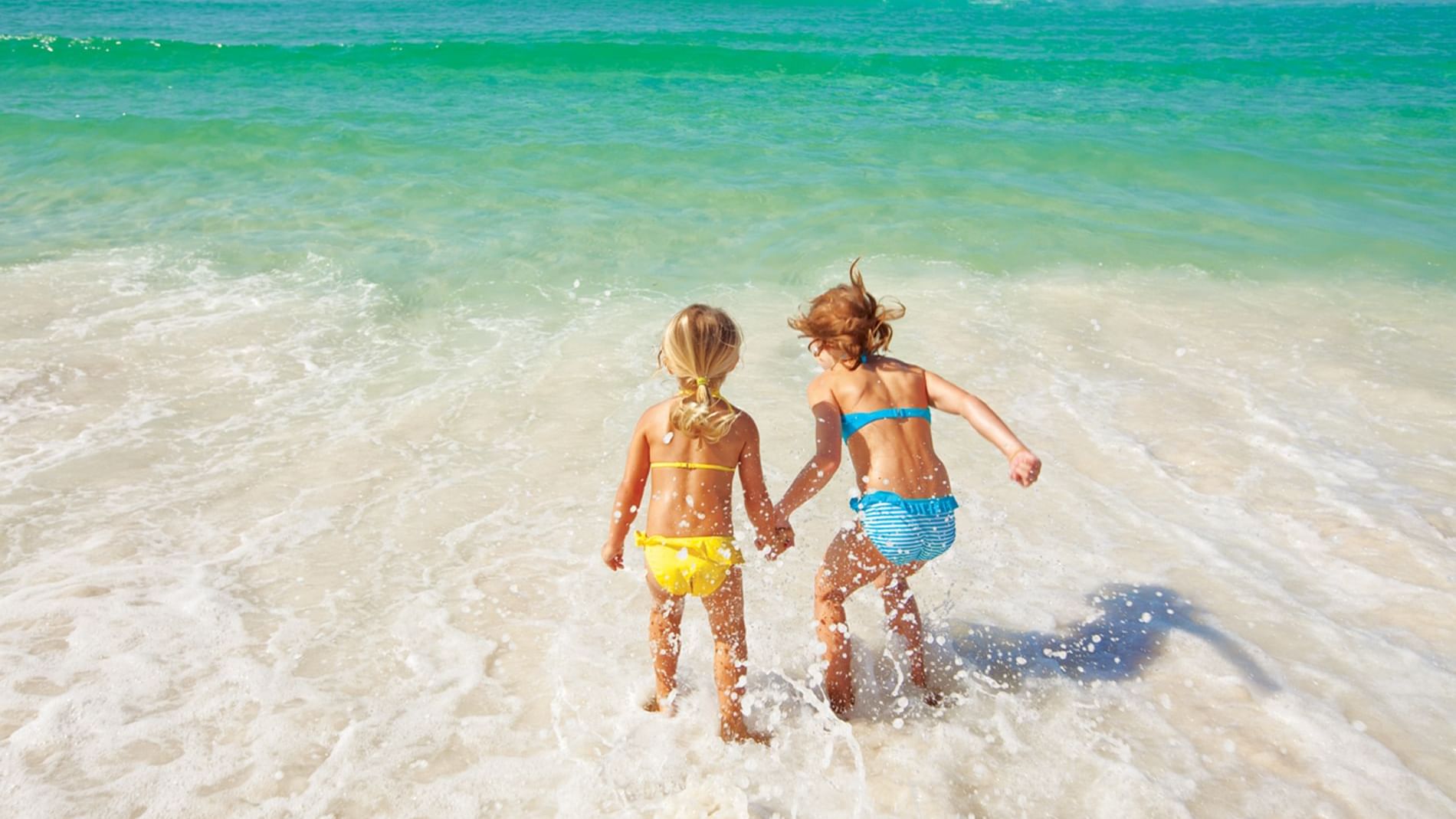 Close-up of two girls playing on the beach at Watersound Inn