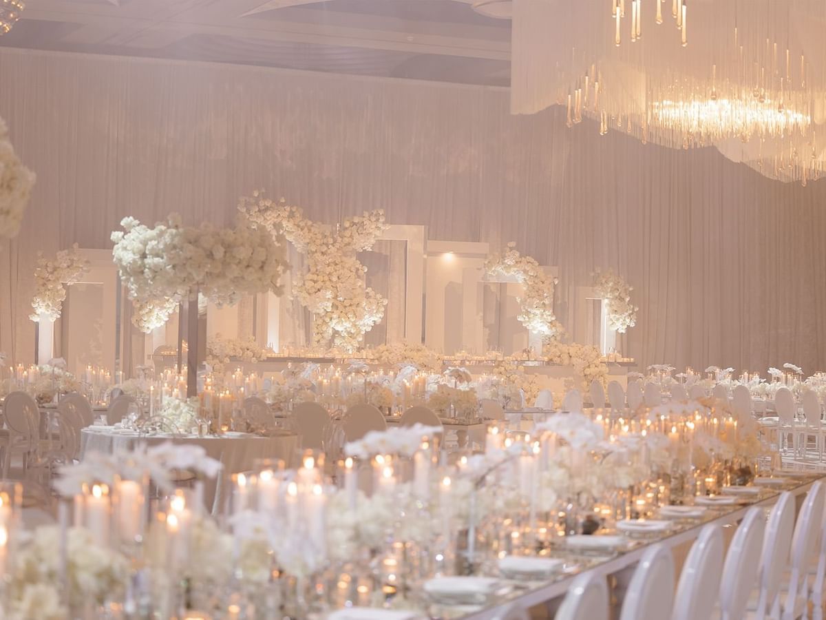 Banquet hall with white floral centerpieces and candles for Paris and Daniel's wedding at Crown Towers Perth