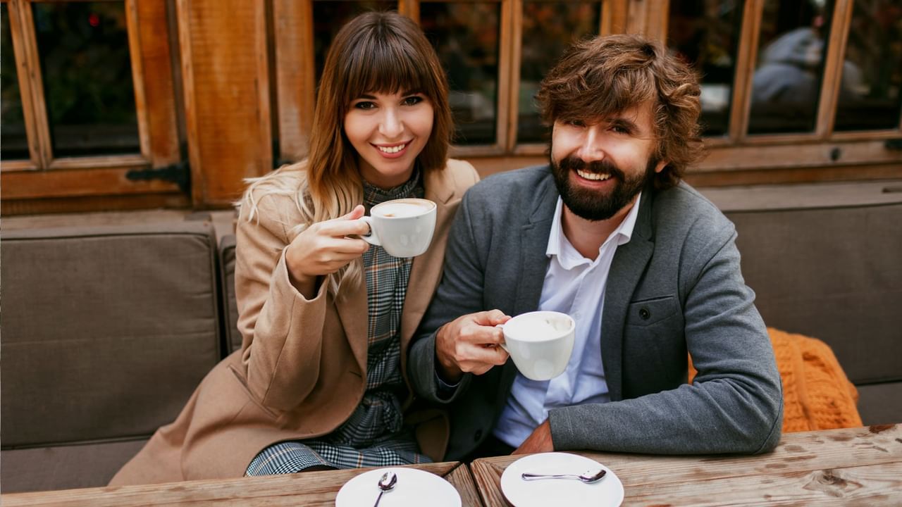 Two people enjoy coffee on a patio in Canmore.