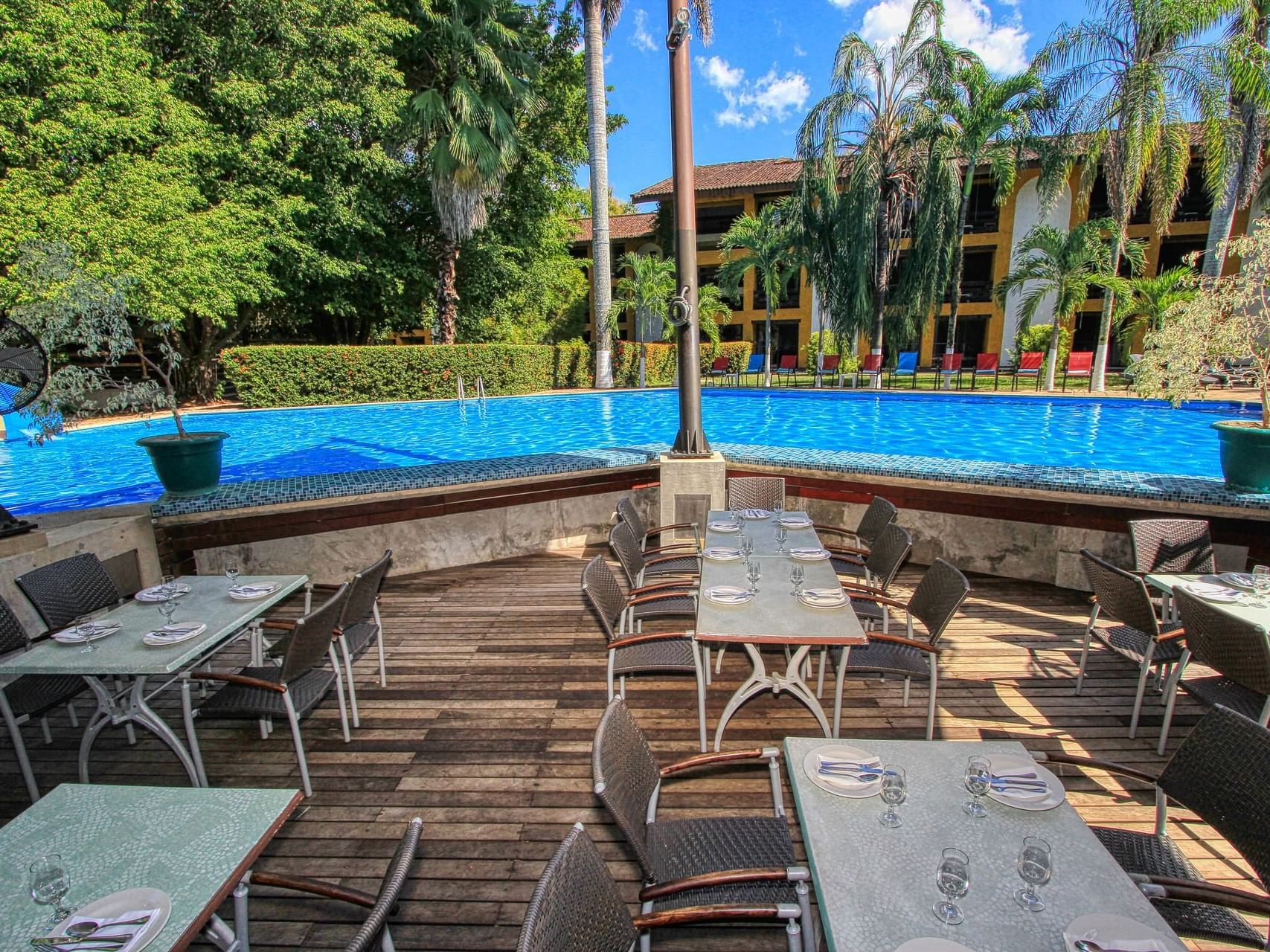 Dining area by the pool in The Palms at Ciudad Real Palenque