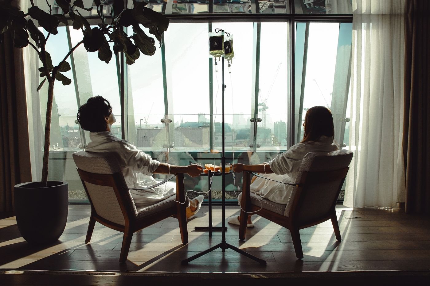 A couple in a robe getting Drip Hydration liquid therapy in a spa at The Londoner