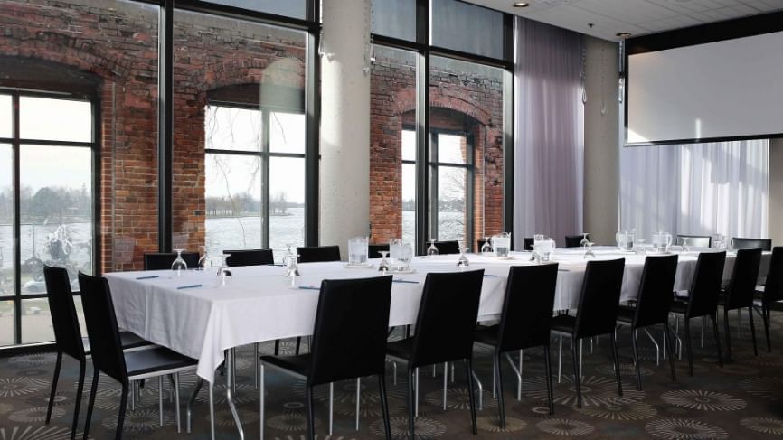 Table with River view in Salon Des Régates at Hotel Moco