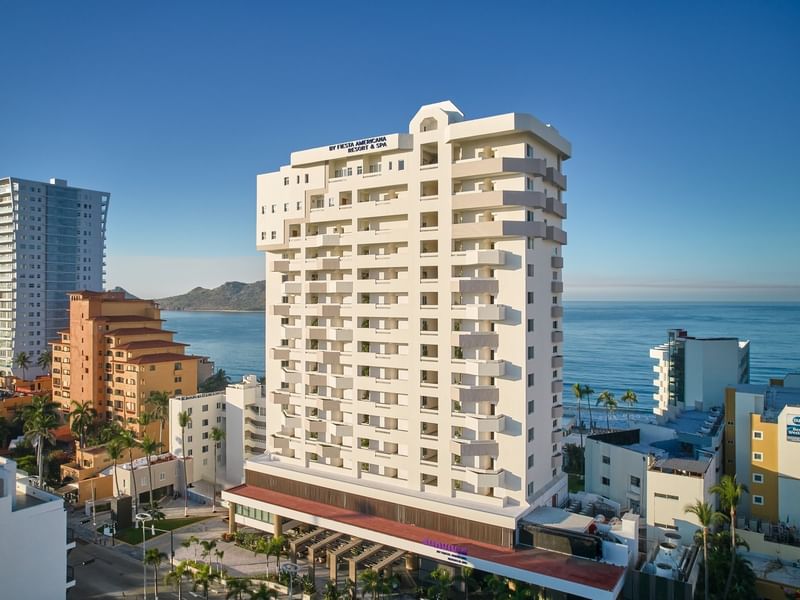 Aerial view of the Sunvivia by Fiesta Americana resort building overlooking the blue ocean and coastline