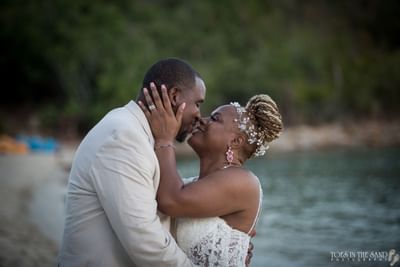 Close-up of a happy wedding couple sharing an intimate, romantic moment on the beach at the Emerald Beach Resort