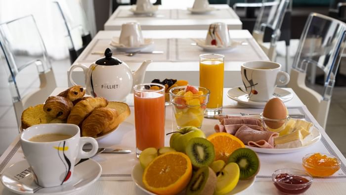 Breakfast table with fruits, juice at Hotel Novella Premium