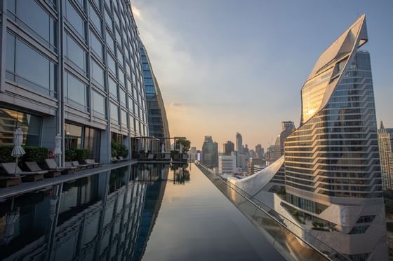 Rooftop pool area with city view at The Okura Prestige Bangkok