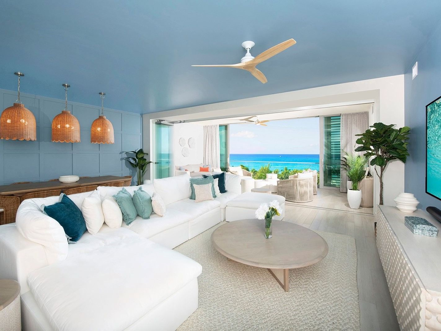 White sectional couch with ocean view in a luxury 3-bedroom condo at Seafire Residences, Grand Cayman.