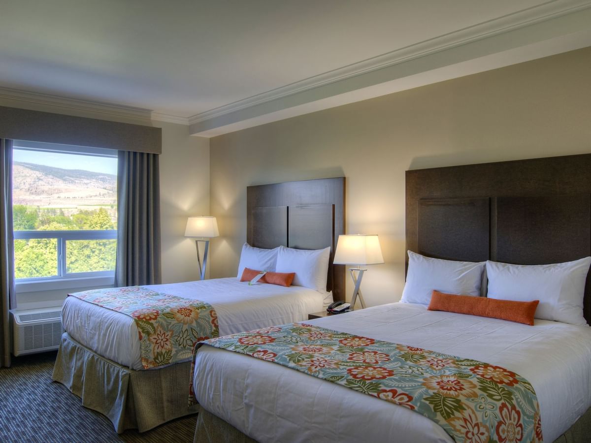 Two beds in hotel room with window