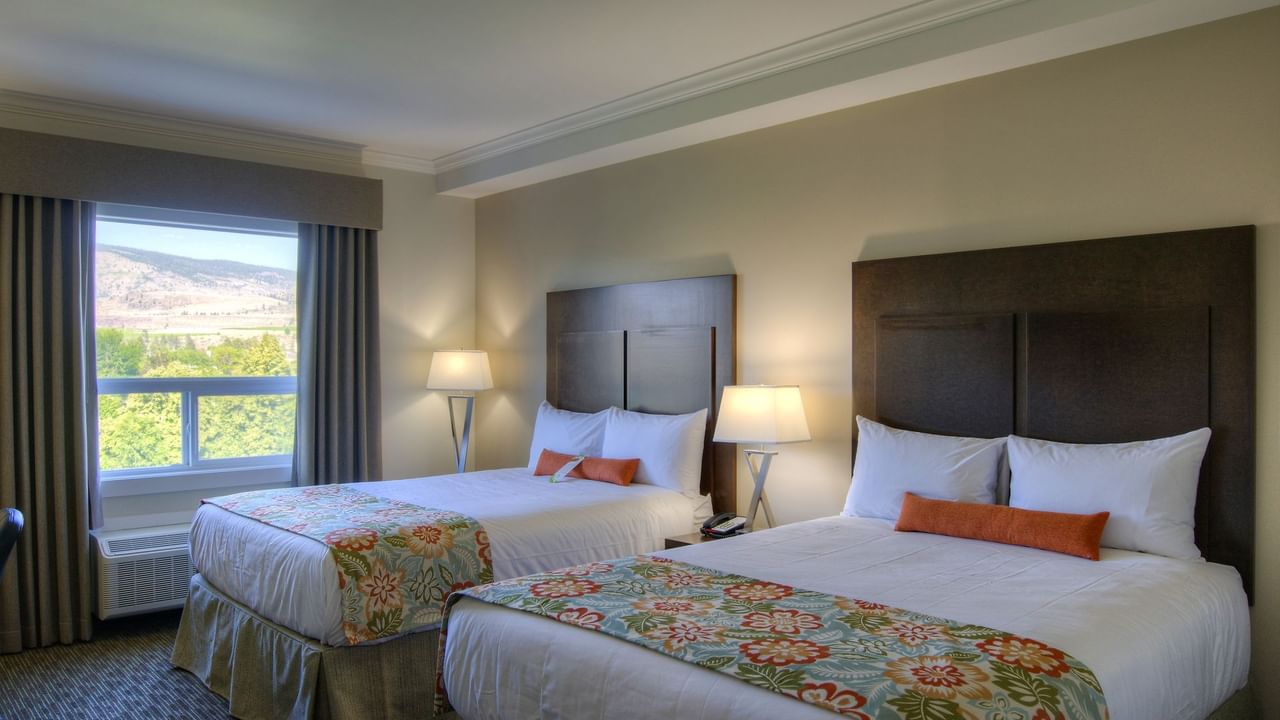 Two beds in hotel room with window