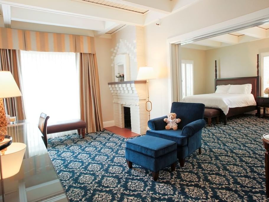 living ropp with accent chair, fireplace and view to bedroom