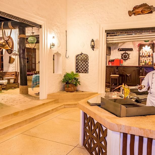 Chef cooking food in Jahazi Grill at Serena Beach Resort & Spa

